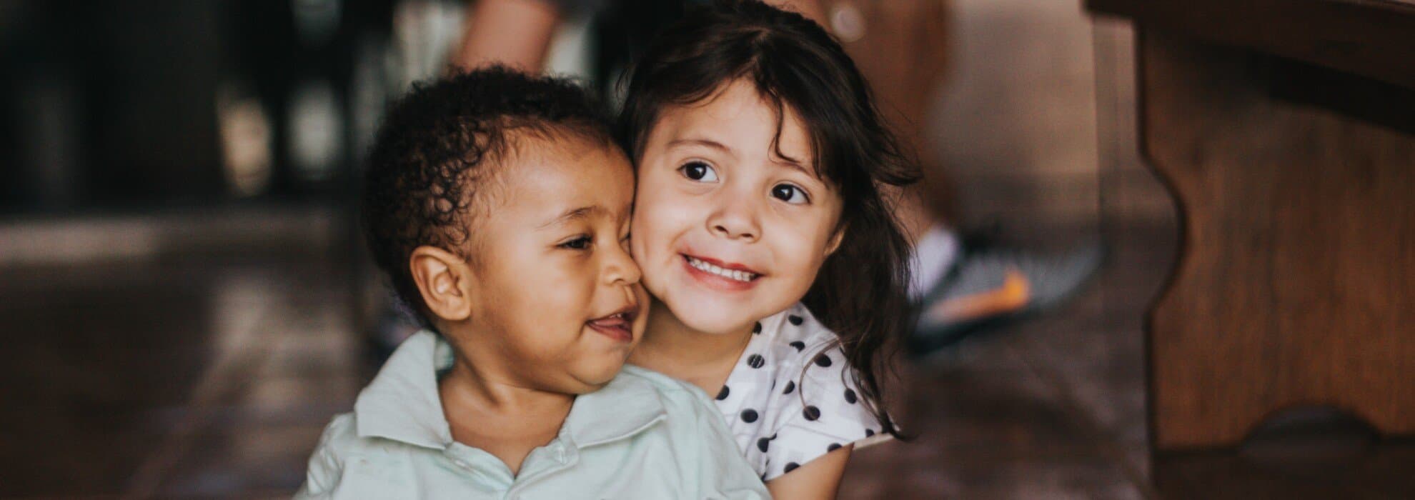Två barn som sitter på golvet Två barn som sitter på golvet